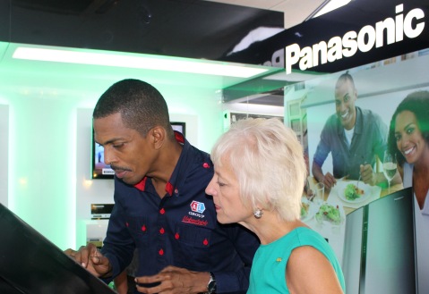 General Manager of Appliance Traders Limited (ATL) Ian Neita (right) demonstrates to Kelly Tomblin, head of the Jamaica Public Service Company (JPS) how to navigate the touchscreen Panasonic Eco-Simulator at the launch of ATL’s Eco Store in Kingston on Thursday June 6. The ATL Eco-Store is Jamaica’s first energy-exclusive retailer and will distribute a range of green electronics including inverter refrigerators and air-conditioners, solar panels as well as LED bulbs.